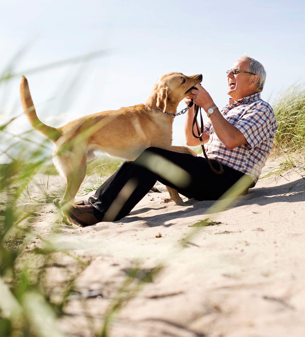 man with his dog on the beach guaranteed income in retirement white bear lake mn